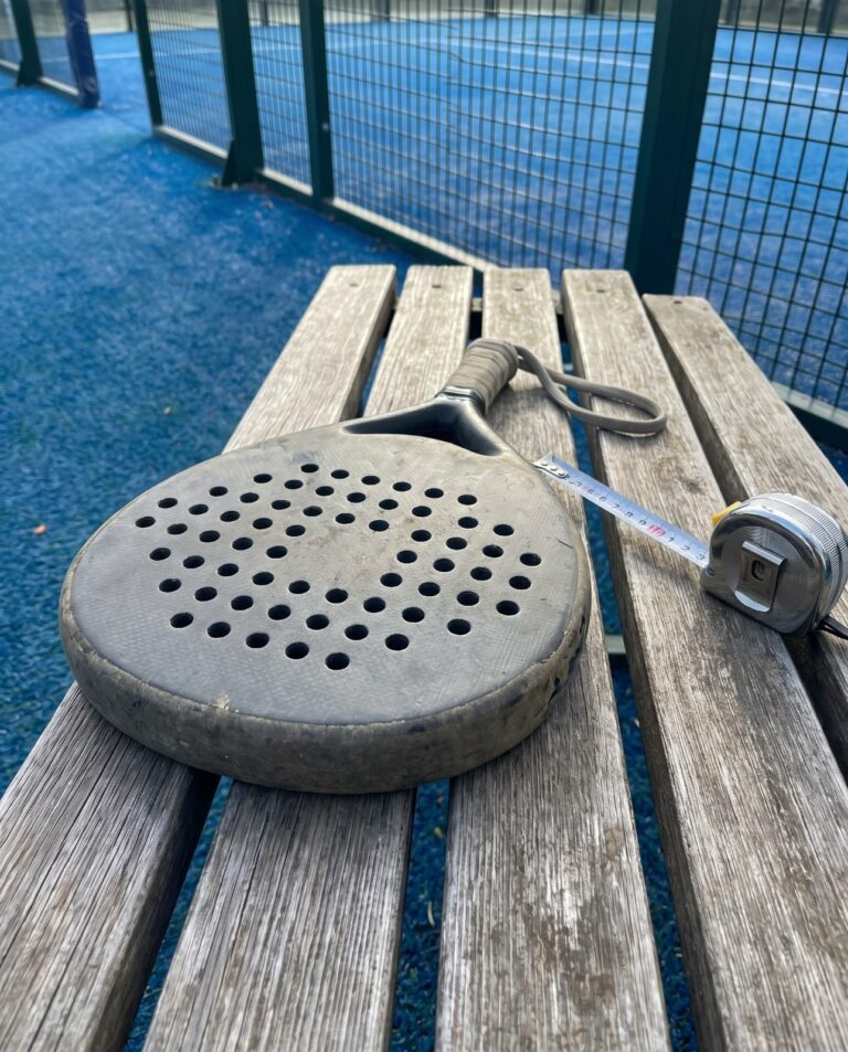 Raquette de padel posée à côté d'un mètre